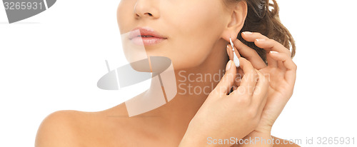 Image of woman wearing shiny diamond earrings