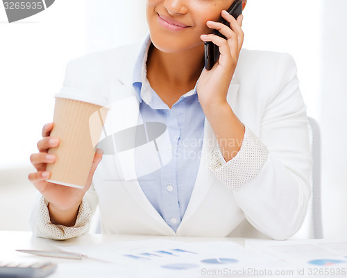 Image of african businesswoman with smartphone in office