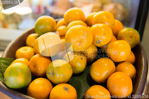 Image of basket of fresh ripe juicy oranges at kitchen