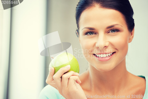 Image of lovely housewife with green apple