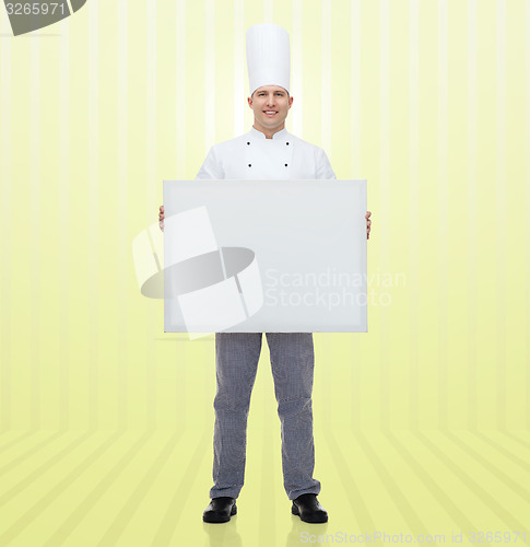 Image of happy male chef cook holding white blank big board