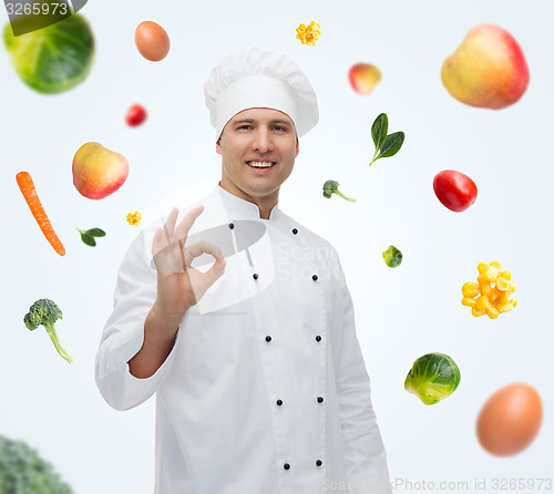 Image of happy male chef cook showing ok sign