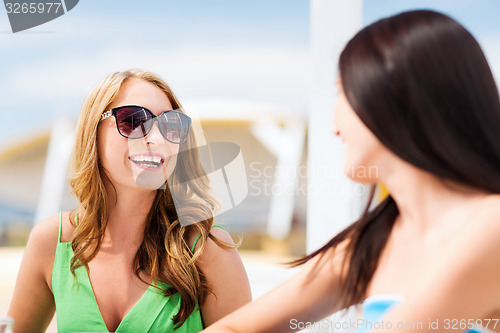 Image of girl in shades in cafe on the beach