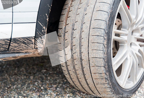 Image of close up of dirty car wheel on ground