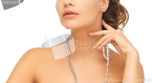 Image of woman with pearl earrings and necklace