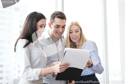 Image of business team looking at clipboard