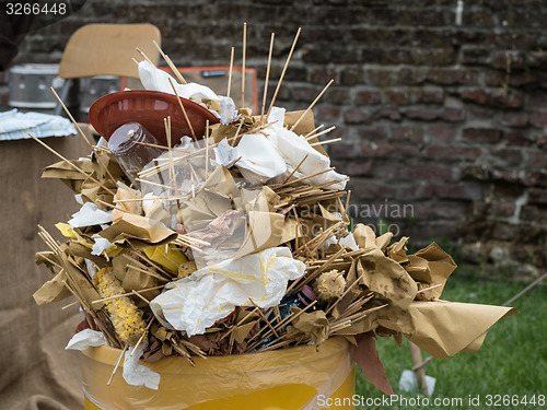 Image of Overfull garbage can trash in festival