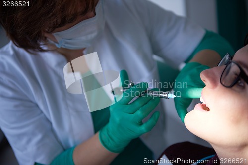 Image of woman patient at the dentist