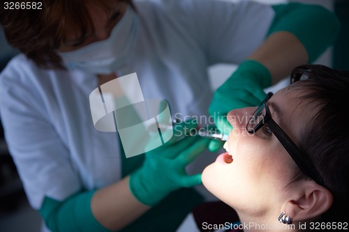 Image of woman patient at the dentist