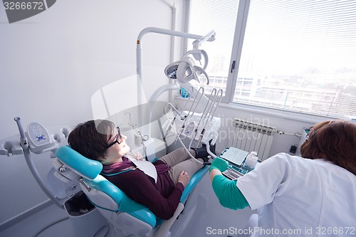 Image of woman patient at the dentist