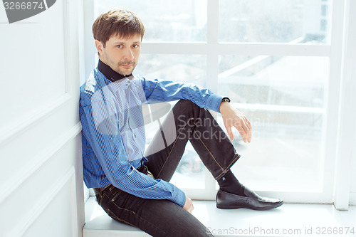 Image of Men portrait at window