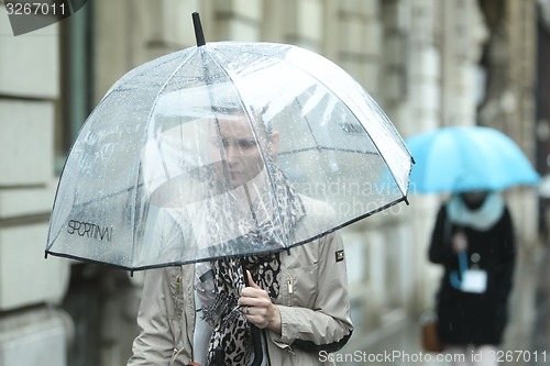 Image of Woman with transparent umbrella on street