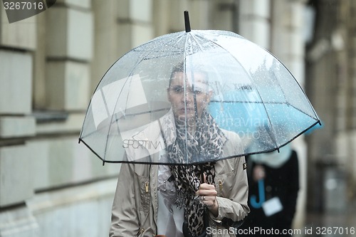 Image of Woman with umbrella on street