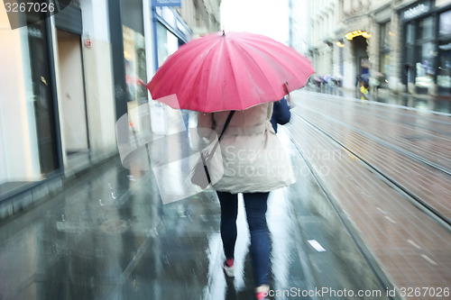 Image of Motion of woman with pink ubrella