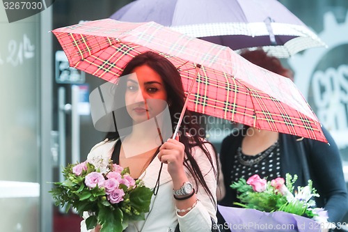 Image of Woman with posy on street