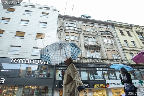 Image of People with umbrellas on rainy day