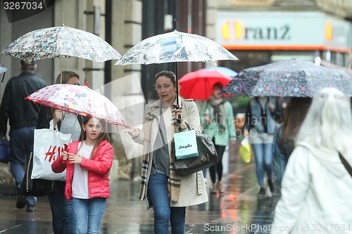 Image of People with umbrellas on street