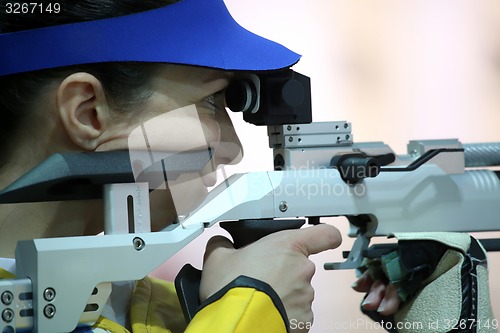 Image of woman aiming a pneumatic air rifle