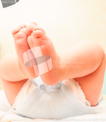 Image of Baby boy with feet in the air after diaper change and bath