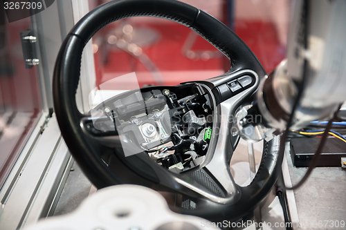 Image of Robotic arm tearing down steering wheel