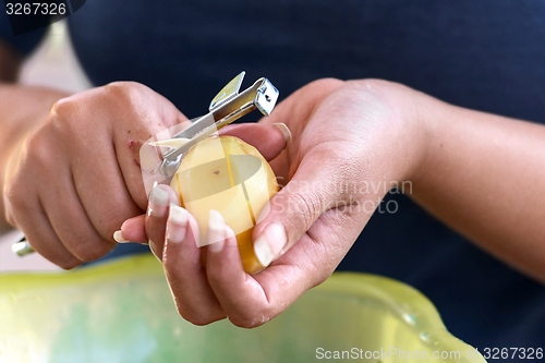 Image of Potato is peeled with a kitchen knife