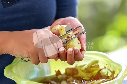 Image of Potato is peeled with a kitchen knife