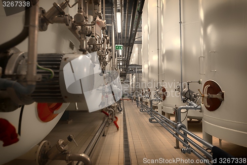 Image of Large industrial white silos in modern factory