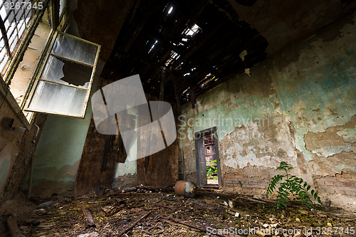 Image of Dark room interior with damaged roof