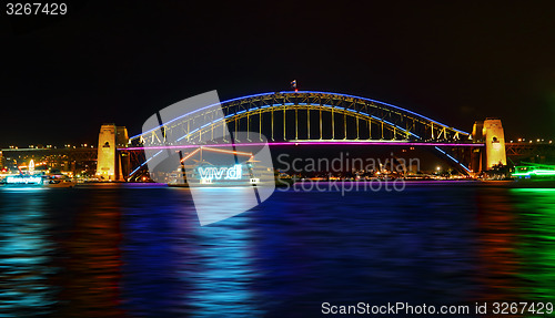 Image of Vivid Sydney- boats cruise by Sydney Harbour Bridge in colour