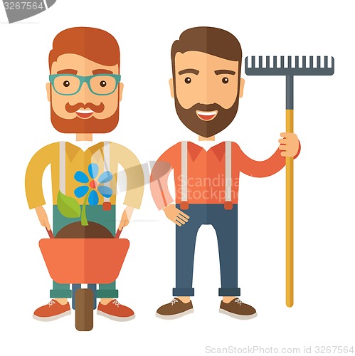 Image of Two men with wheelbarrow and rake.