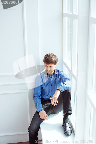 Image of Men portrait at window