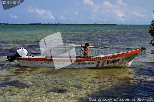 Image of a man and his white boat