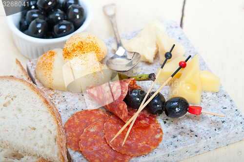 Image of mix cold cut on a stone with fresh pears