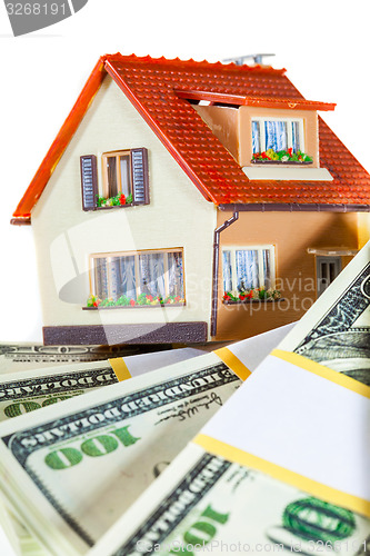 Image of house on packs of banknotes