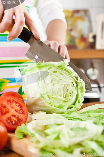 Image of Woman\'s hands cutting vegetables