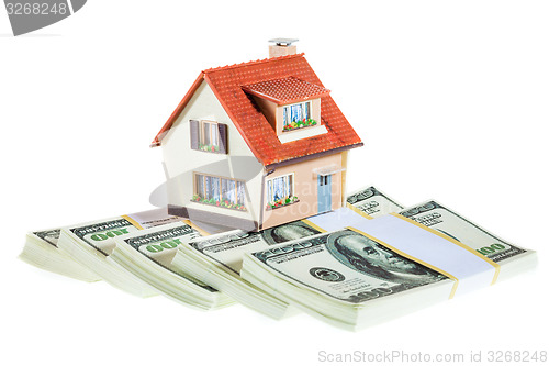 Image of house on packs of banknotes