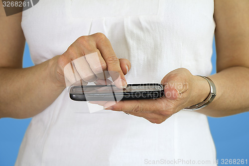 Image of Young woman using cellphone