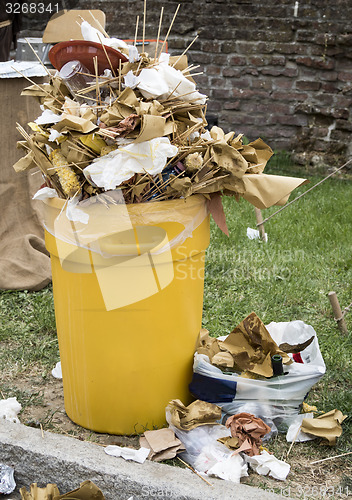 Image of Overfull garbage can trash in festival