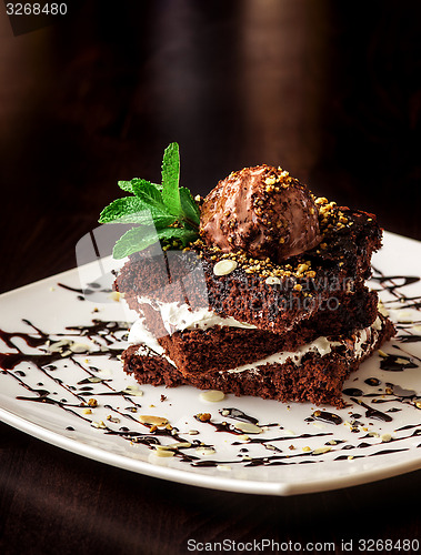 Image of Chocolate brownie cake with a scoop of ice cream.