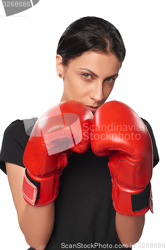 Image of Serious business woman wearing boxing gloves