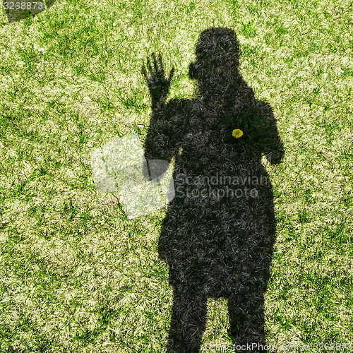 Image of Shadow of a woman waving her hand