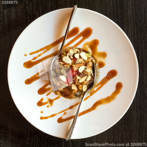 Image of White plate with eel, avocado and sliced almonds