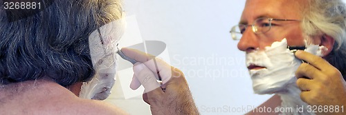 Image of man shaving in mirror