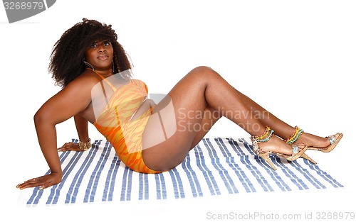 Image of African woman sitting in bikini.