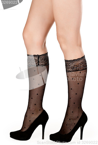 Image of female legs in fishnet socks and shoes