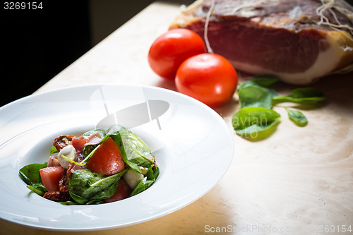 Image of Salad with strawberry, prosciutto, herbs, cottage cheese and blackberry balsamic vinegar.