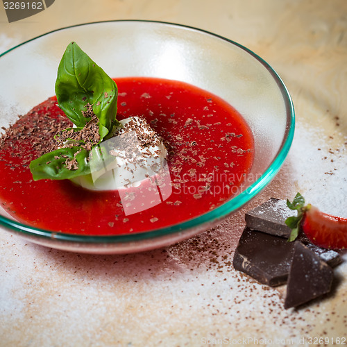 Image of strawberry soup with ice cream and mint on a plate decoratedfresh strawberries