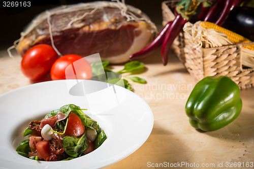 Image of Salad with strawberry, prosciutto, herbs, cottage cheese and blackberry balsamic vinegar.