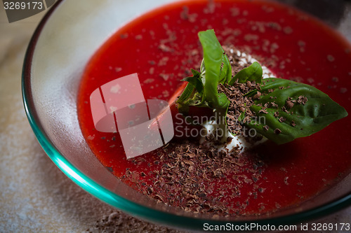 Image of strawberry soup with ice cream and mint on a plate decoratedfresh strawberries