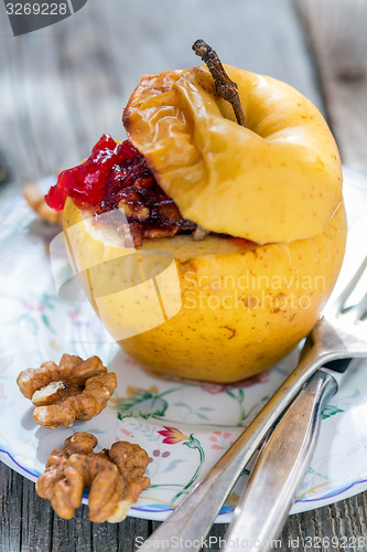 Image of Baked apple with nuts closeup.